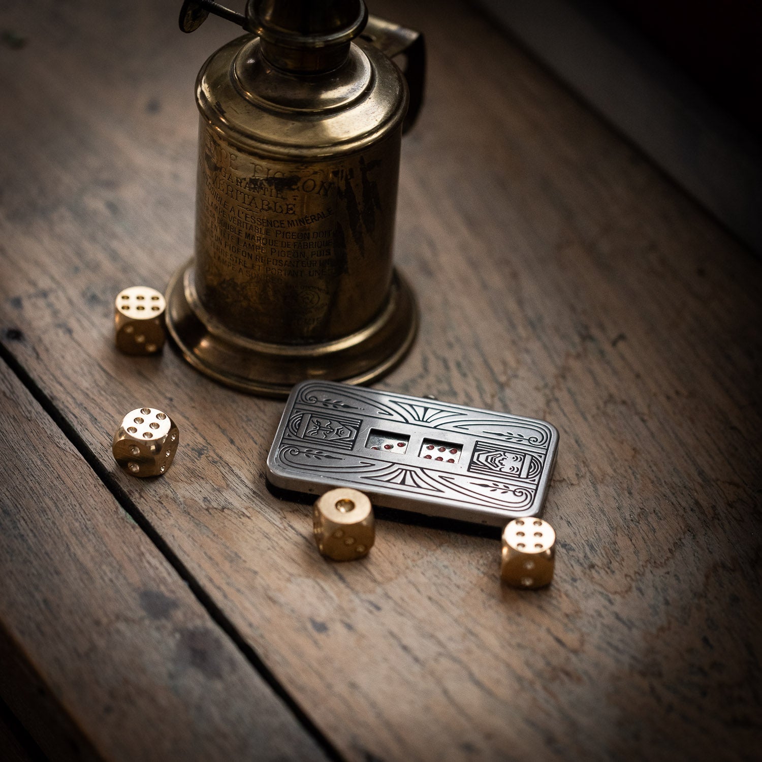 Demley NY Mechanical Dice next to brass dice