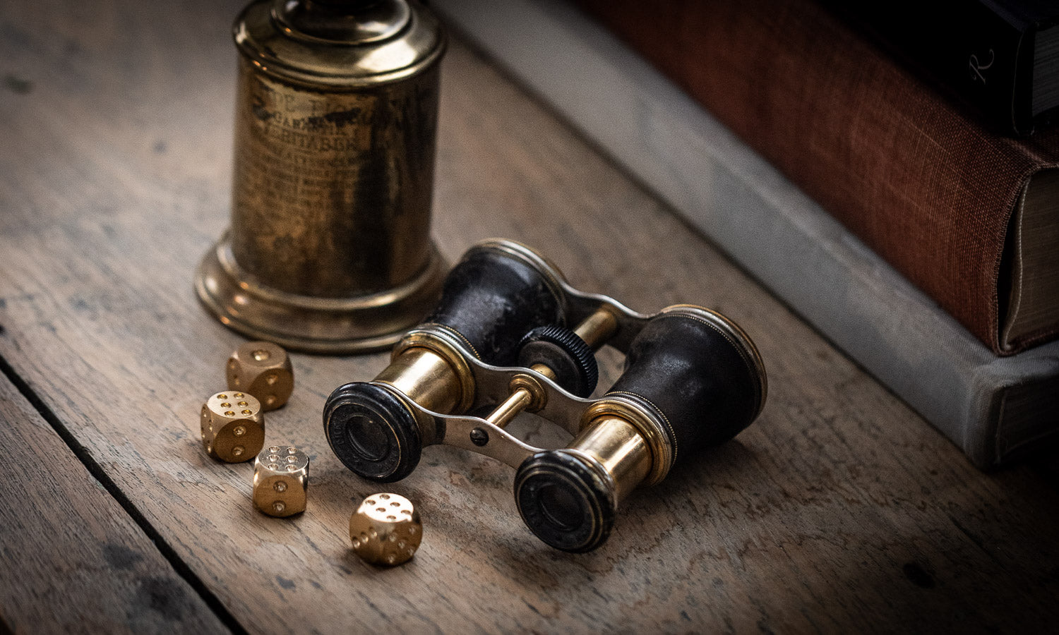 Image of vintage opera binoculars with vintage brass lamp and brass dice