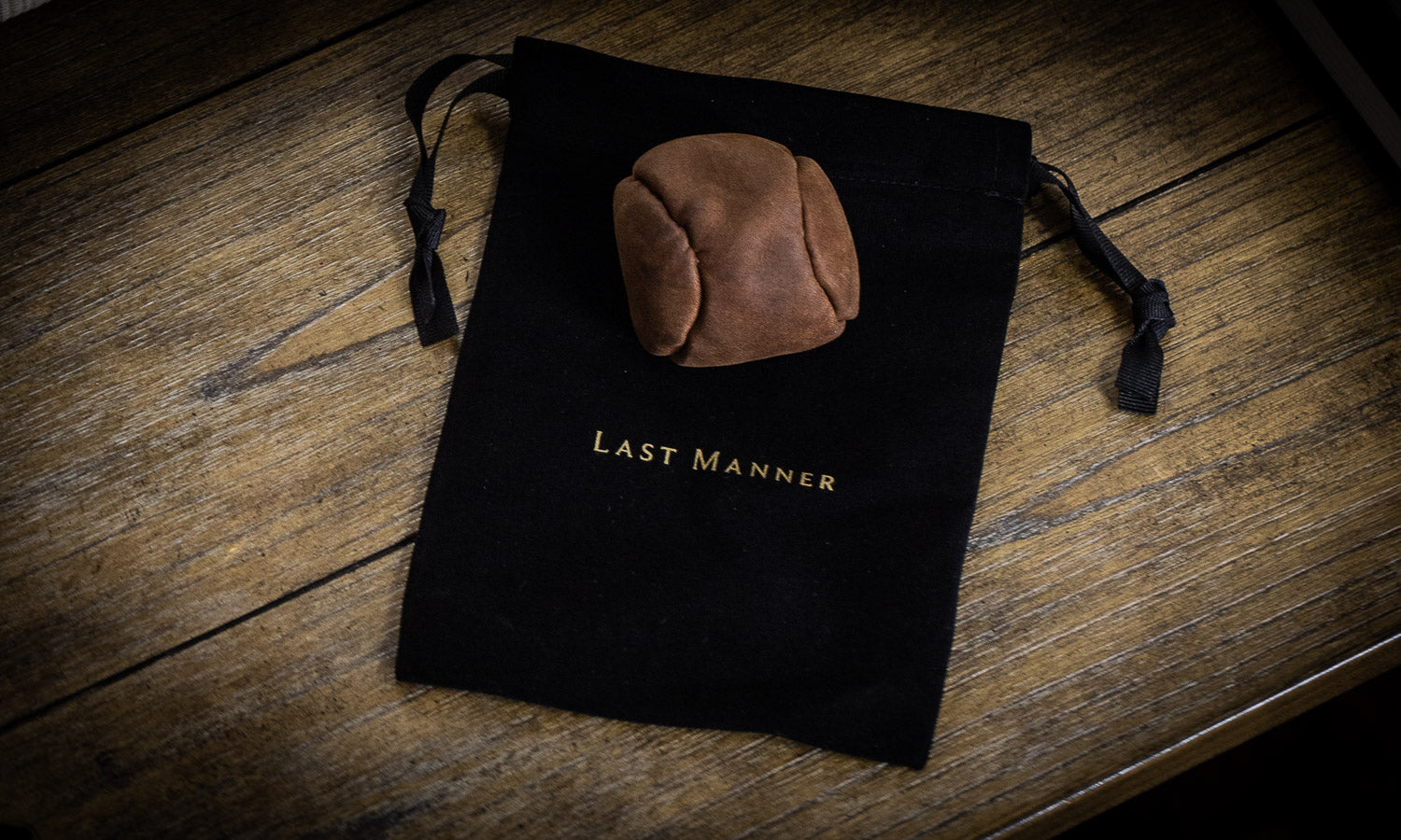 image of leather hacky sack on Last Manner velvet bag