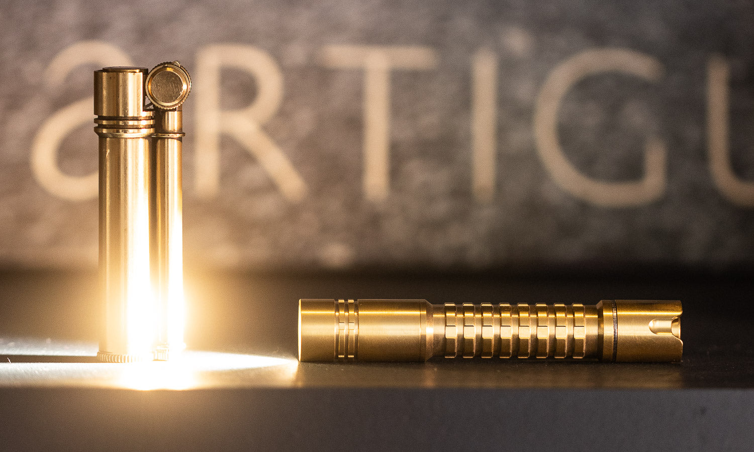 brass flashlight with frag pattern illuminating a tokyo pipe co field l brass lighter