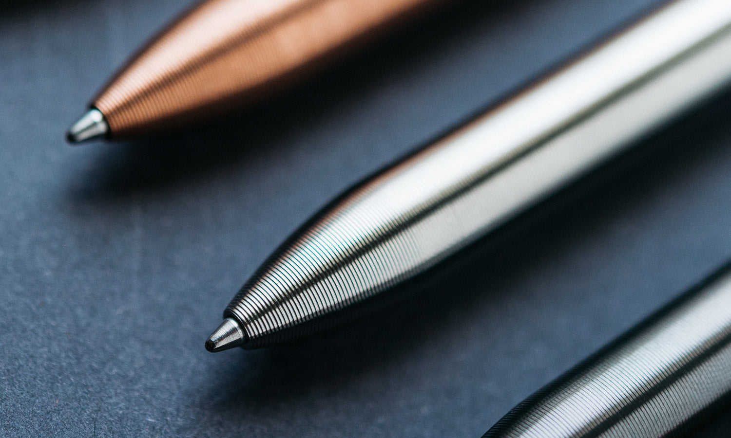Titanium pen with grooves