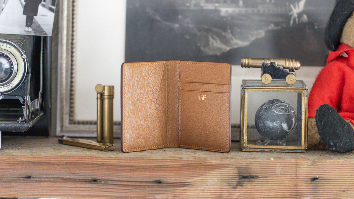 A Last Manner cordovan wallet sitting open on a shelf